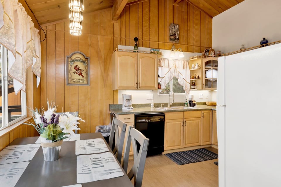 Dining area with a spacious table and a fully equipped kitchen for easy meals and entertaining