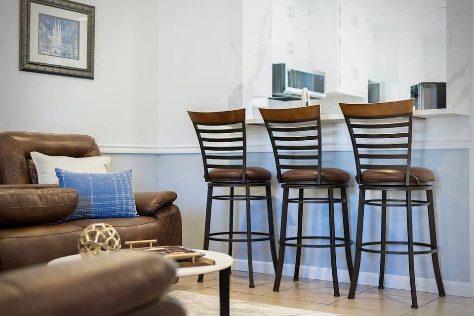Living Room: Modern gathering space with stylish seating and a breakfast bar—ideal for relaxing evenings in Temple TX near local medical centers.