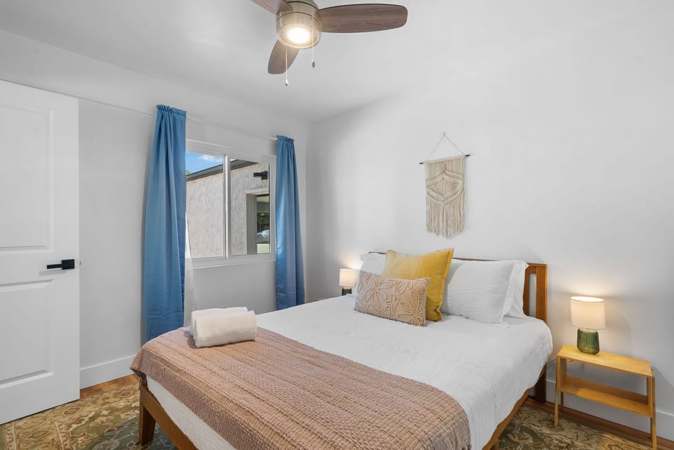 This room feels cozy and inviting with its soft tones and natural light!