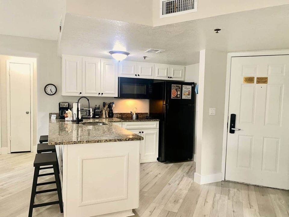 Fully equipped kitchen with electric cooktop,  full size fridge, microwave, toaster oven, dishwasher, waffle maker, coffee maker, all utensils - Sea World Orlando Apartments
