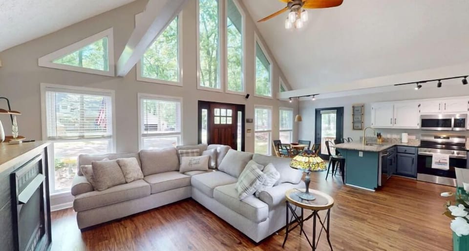 Living area with comfortable couch, smart TV, and gas fireplace.