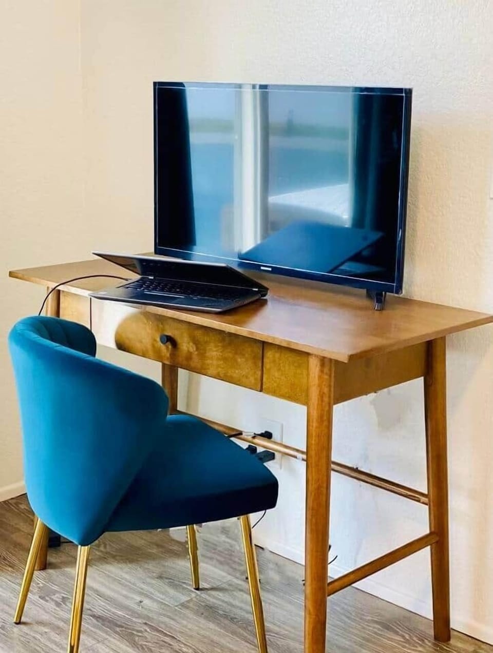 Velvet chair with a desk are located in the primary bedroom so you can shut the door to work from our home (laptop not included). Take a quick dip in the pool when you take a break from work.