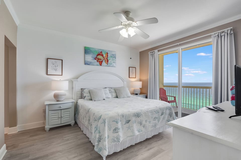 Relaxing bedroom with balcony access—wake to turquoise Gulf views and sea breeze