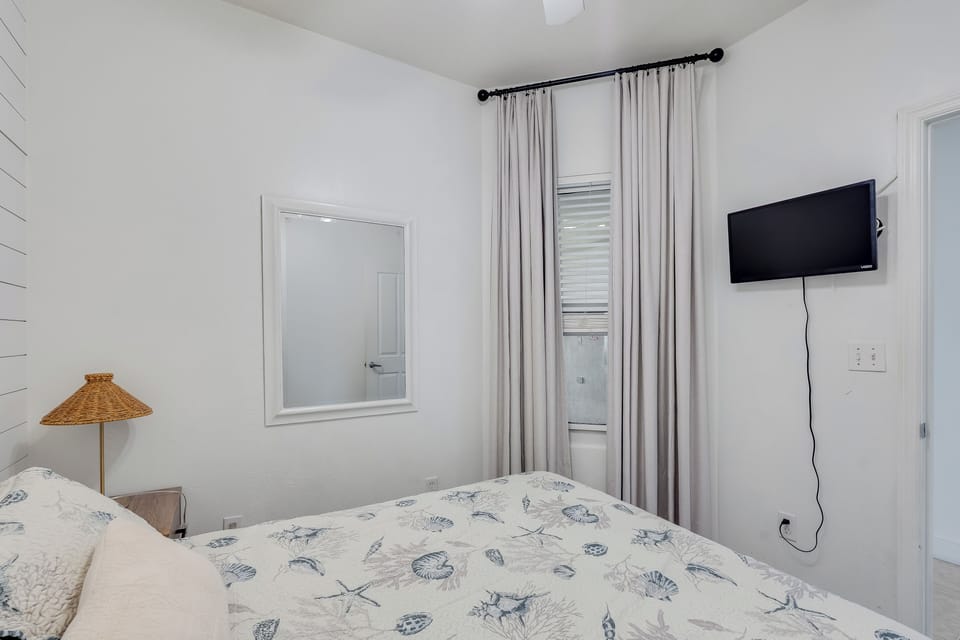 Cozy guest bedroom with hotel‑quality mattress—rest easy in coastal comfort