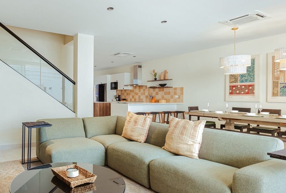 Cozy living room with comfortable seating, smart TV, natural light, and inviting atmosphere.