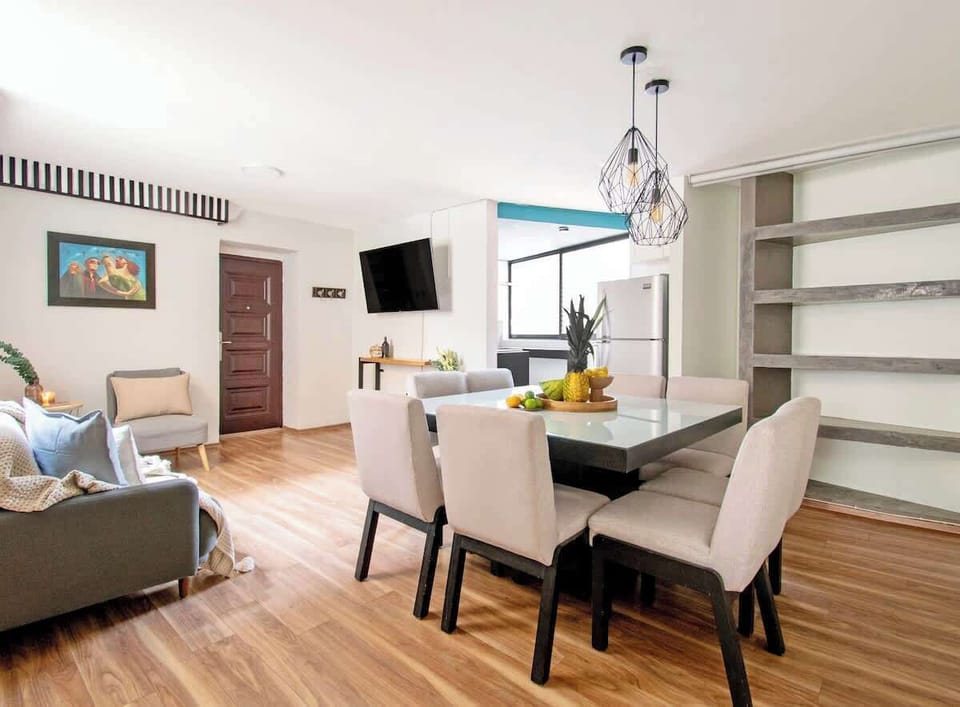 Spacious open-plan layout combining living, dining and kitchen areas — bright and perfect for group gatherings.