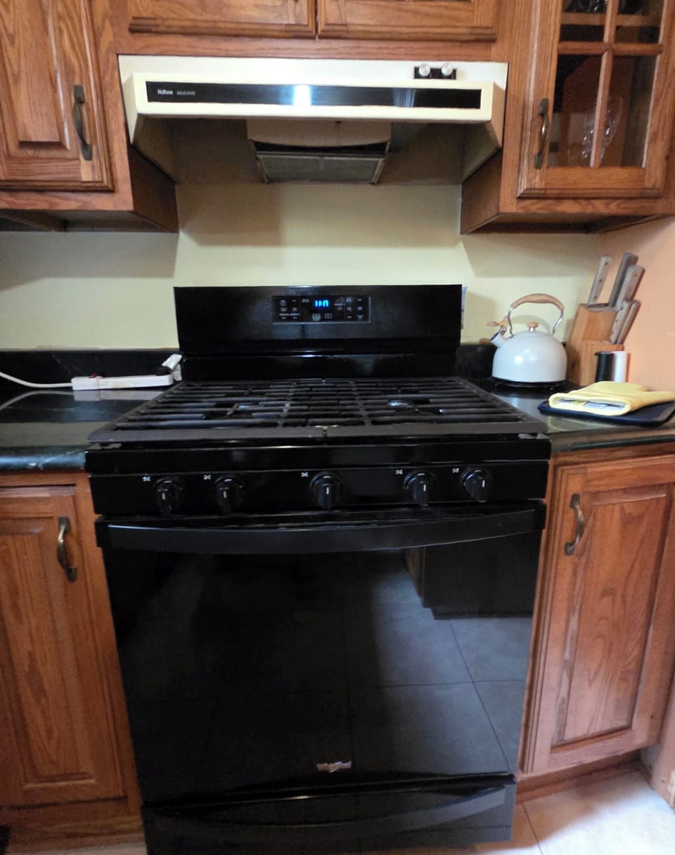 gas stove/oven, knife block, tea kettle