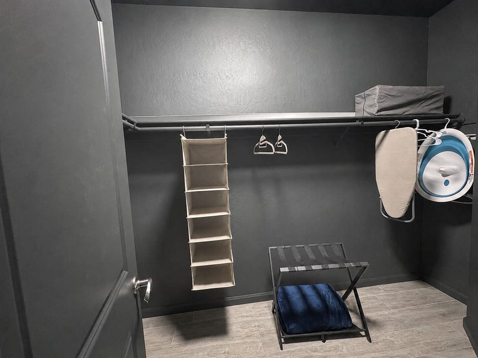 Master closet; baby bath, baby play pen,  ironing board.