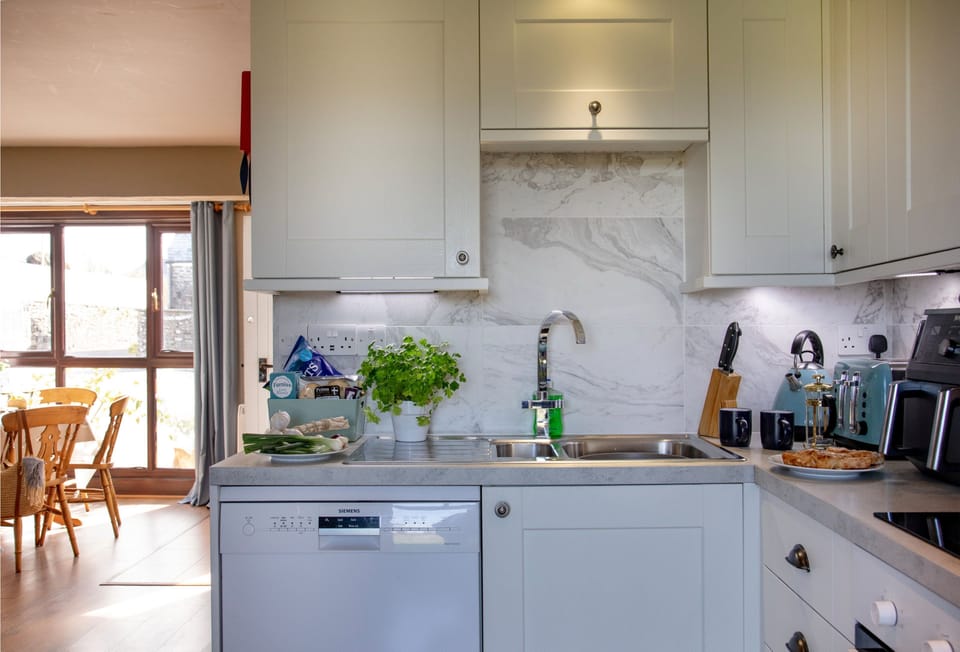Toad Hall, Bude, Cornwall: A spacious kitchen complete with a welcome hamper to make your arrival extra special