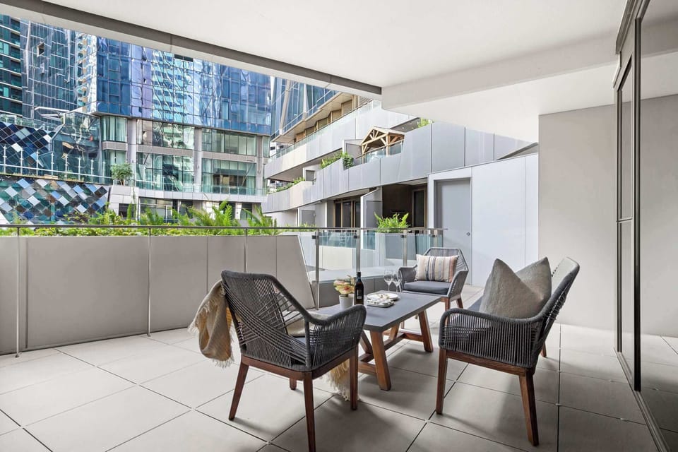 A large private balcony with an outdoor setting.