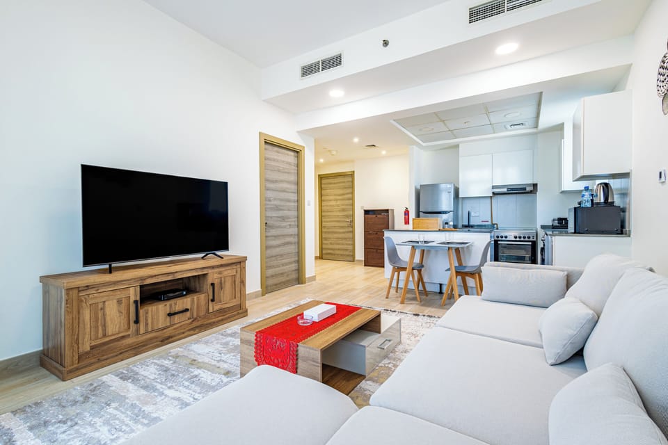 Apartment, Balcony, City View | Living area | 55-inch LCD TV with digital channels