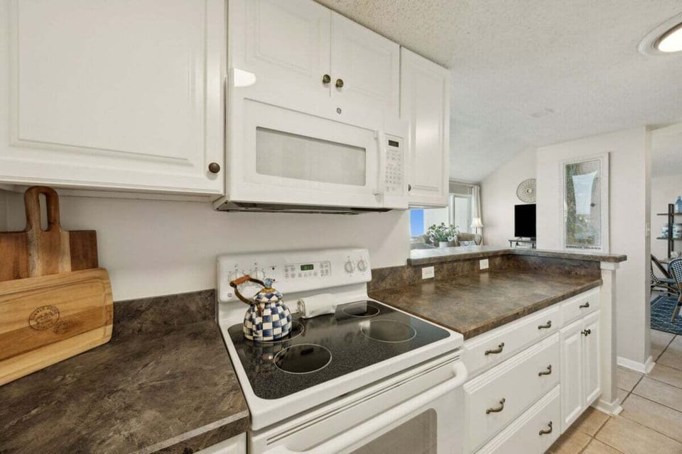 A classic coastal kitchen offering comfort and convenience, perfect for preparing beachside breakfasts or evening dinners in.
