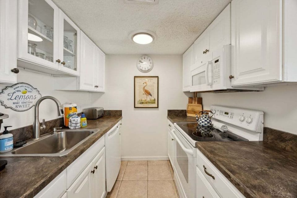 A classic coastal kitchen offering comfort and convenience, perfect for preparing beachside breakfasts or evening dinners in.