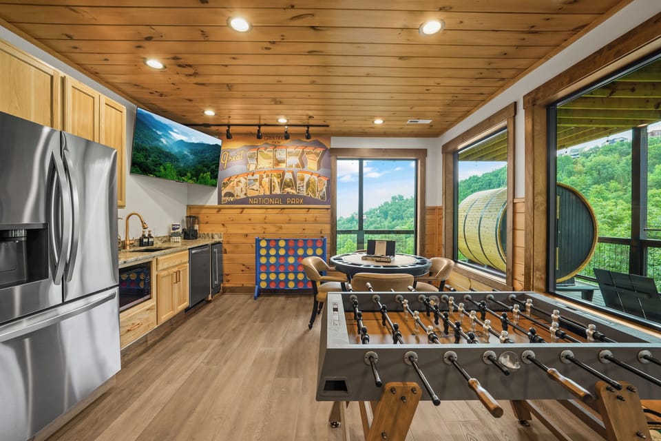Ultimate Game Room -Watch movies or the big game on the 100-inch TV, relax on the plush sectional, or enjoy bar-top seating. Play pool, shuffleboard, foosball, and arcade tables, with a kitchenette for snacks and drinks—perfect for family fun & game nights