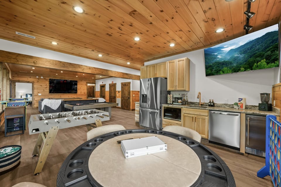 Ultimate Game Room -Watch movies or the big game on the 100-inch TV, relax on the plush sectional, or enjoy bar-top seating. Play pool, shuffleboard, foosball, and arcade tables, with a kitchenette for snacks and drinks—perfect for family fun & game nights