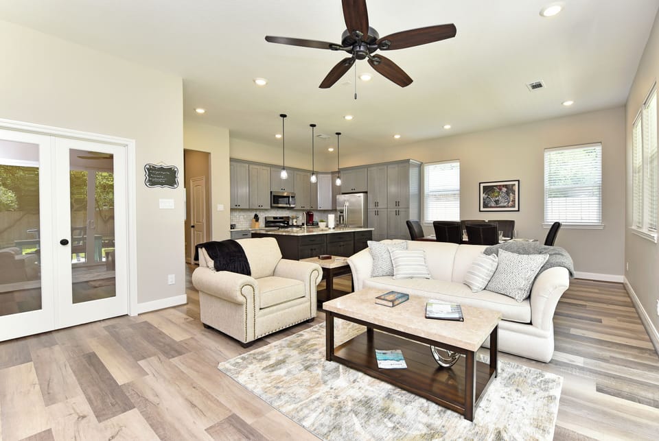 The living room has plenty of comfy seating and a welcoming feel.