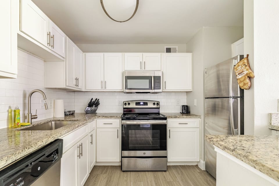 Bright modern kitchen with granite counters and stainless appliances