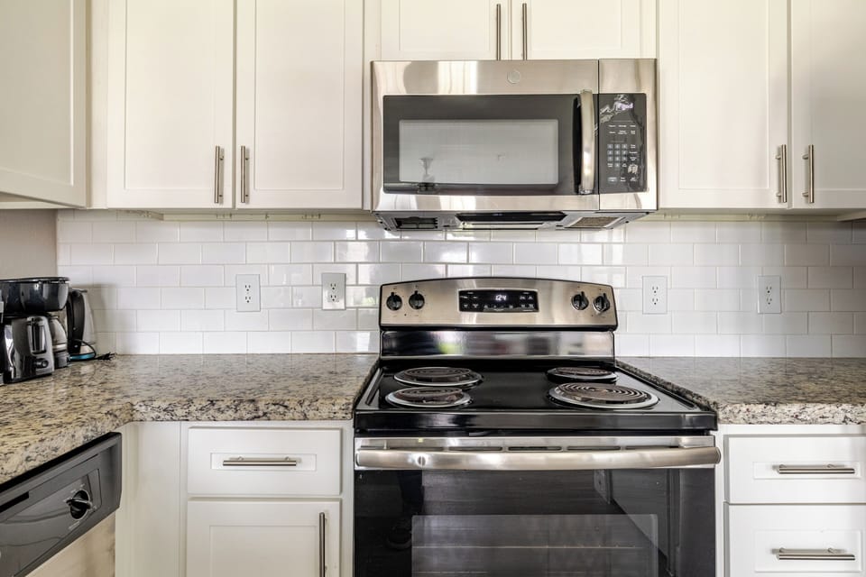 Bright modern kitchen with granite counters and stainless appliances