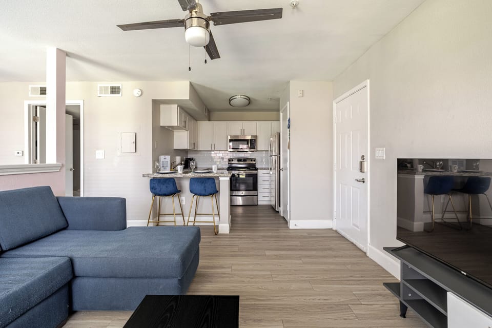 Bright open living space with modern kitchen and cozy sectional