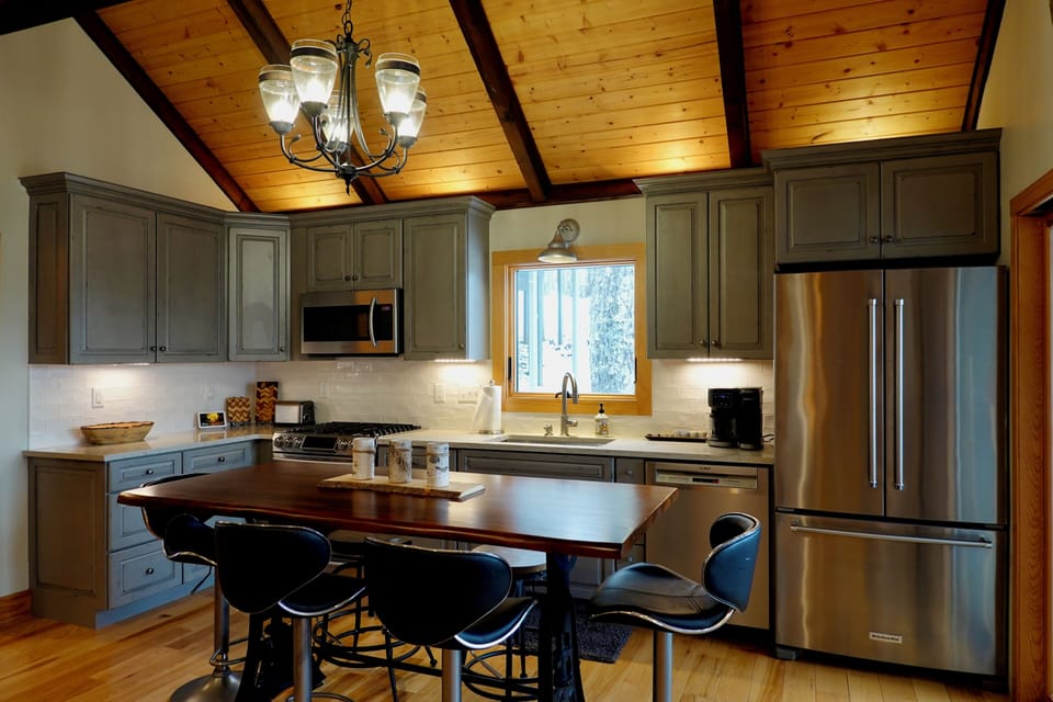 Kitchen with 6 seat table, premium cookware, flatware, accessories, and tools