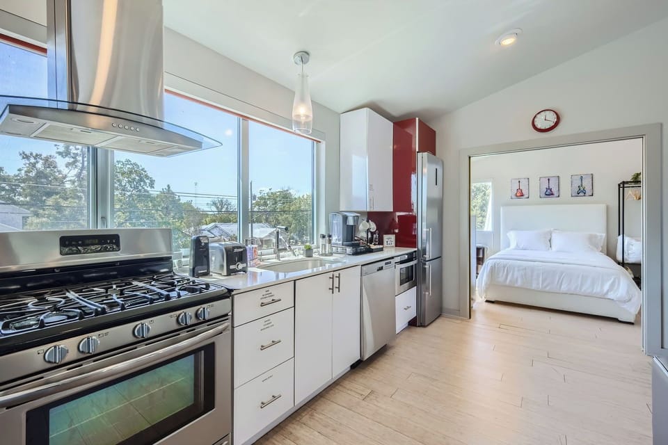 Guest House Full Kitchen with View of Queen-Sized Bedroom