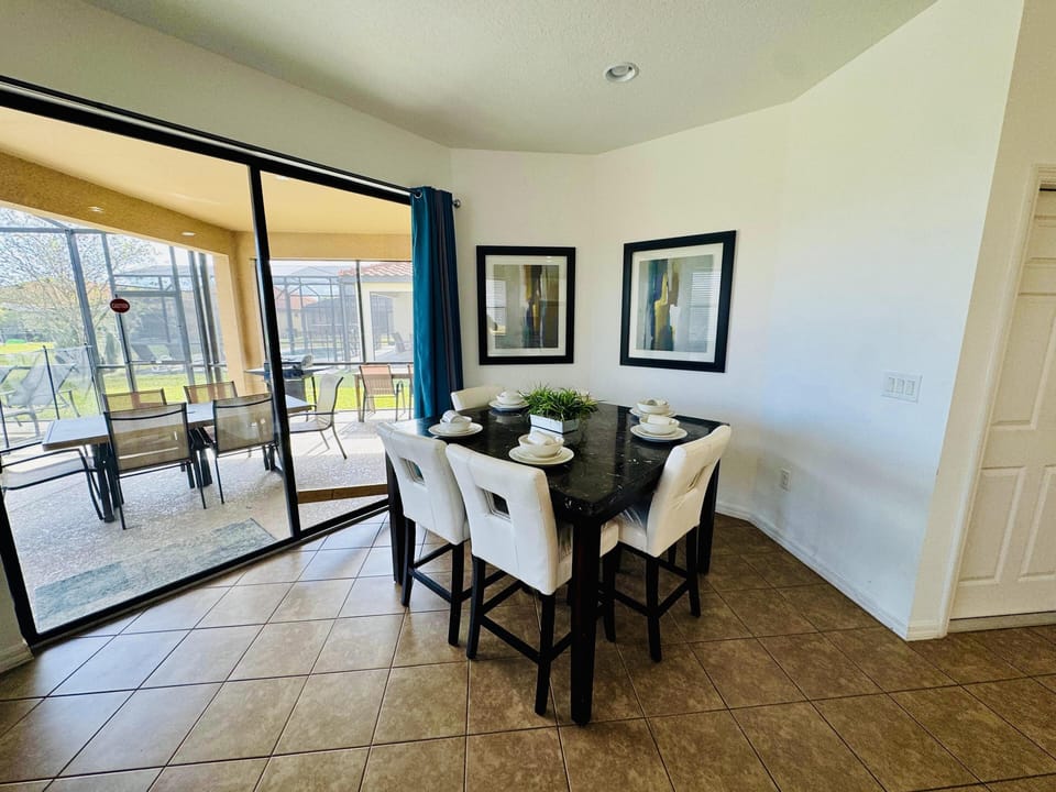 Bright dining area with scenic balcony views and natural light