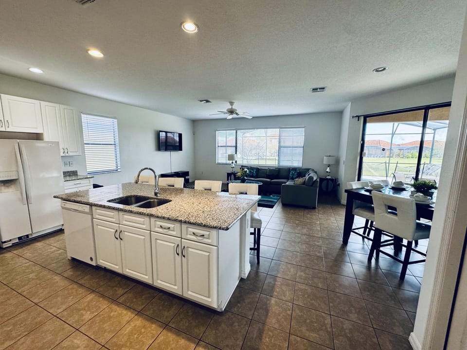 Spacious open-concept kitchen and living area with natural light