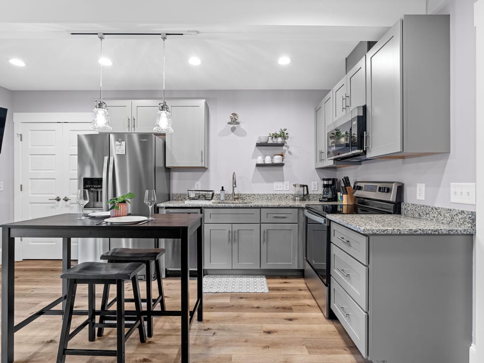 Modern kitchen with granite counters, island seating, and stainless appliances
