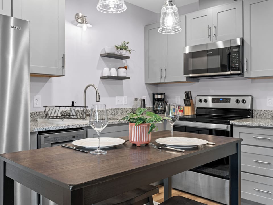 Modern kitchen with stainless appliances and a cozy dining island for two