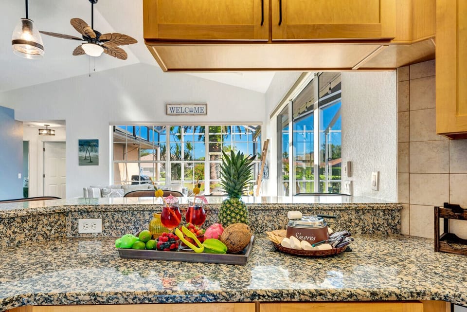 Kitchen | Granite Countertops, Stainless Steel Appliances, and Poolside View with Breakfast Bar