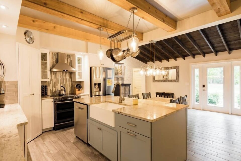 Beautiful fully stocked kitchen with and island that has the kitchen sink and dishwasher and an attached dining table!