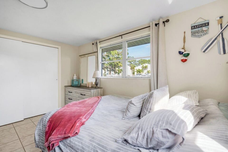 Bedroom 2- Queen Bed with twin Bunk Beds. Elegance meets practicality in this bedroom adorned with a sleek dresser, offering ample clothing storage.