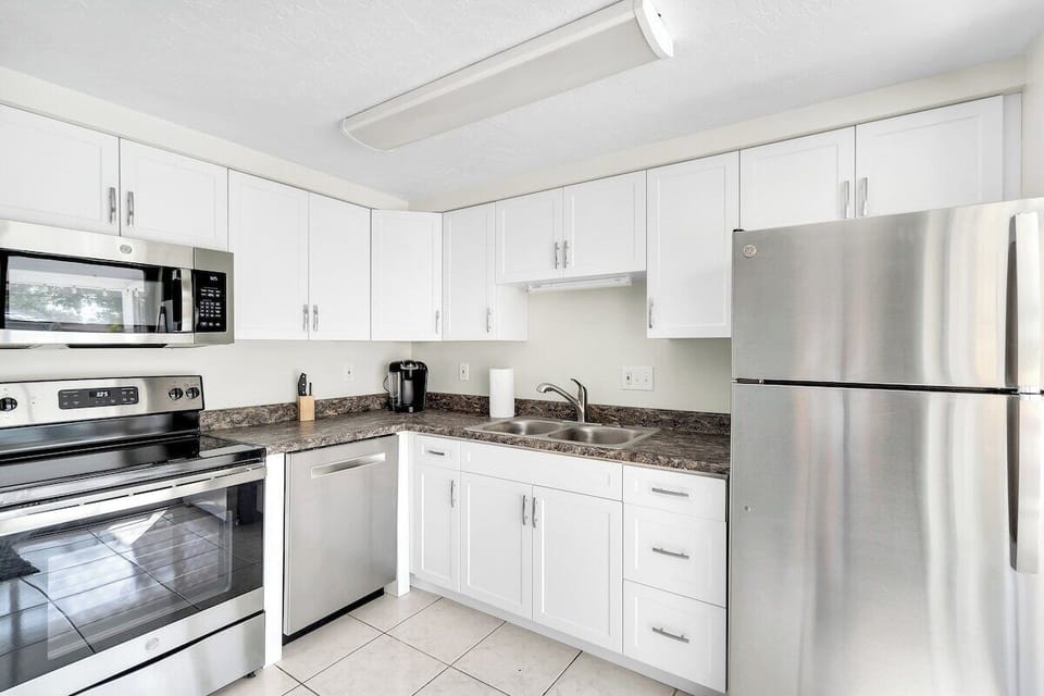 The kitchen is fully stocked with cooking utensils, pots, pans, dishes and silverware so you can make your favorite meals even while on vacation