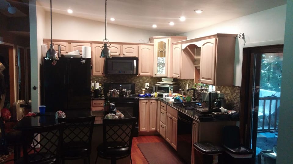 Fully equipped open kitchen adjacent to screened porch
