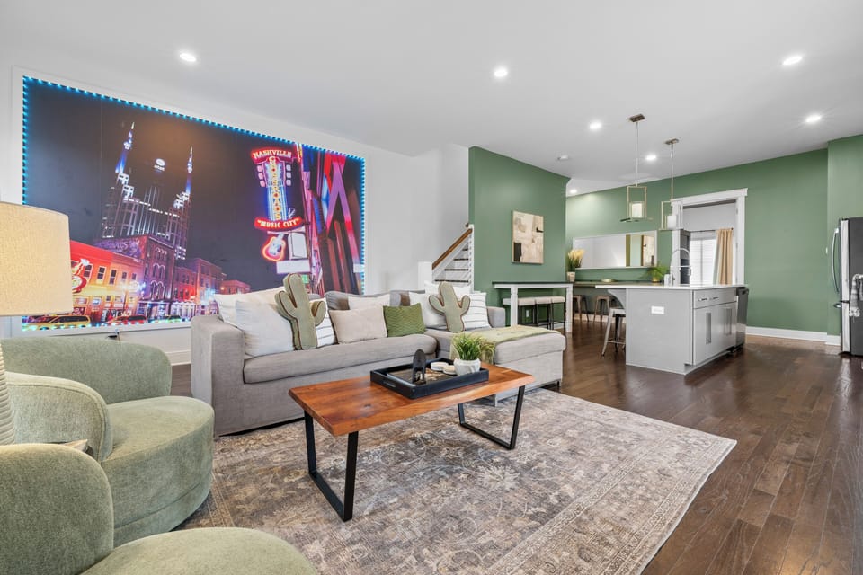Stylish open living with Nashville mural and modern chef’s kitchen
