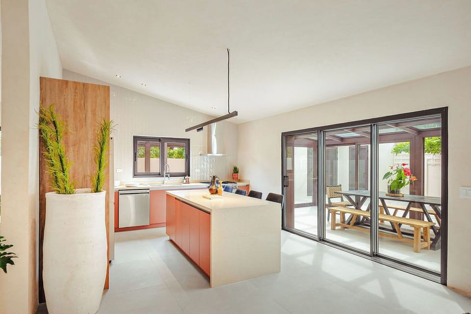 Dinner al fresco, anyone? Our fully equipped, modern kitchen flows seamlessly through expansive sliding doors to your private outdoor dining area. Perfect for gathering, grilling, and making memories under the sky.