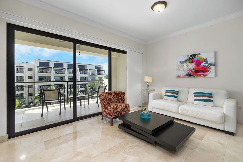 Step into comfort and style! This inviting unit boasts a bright and airy living space, complete with a modern sofa and unique armchair, leading out to a generous balcony. Enjoy your morning coffee with a view or an evening drink under the stars.