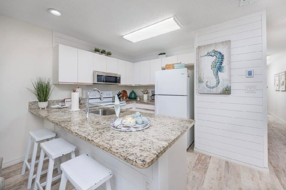 Counter with three stools.