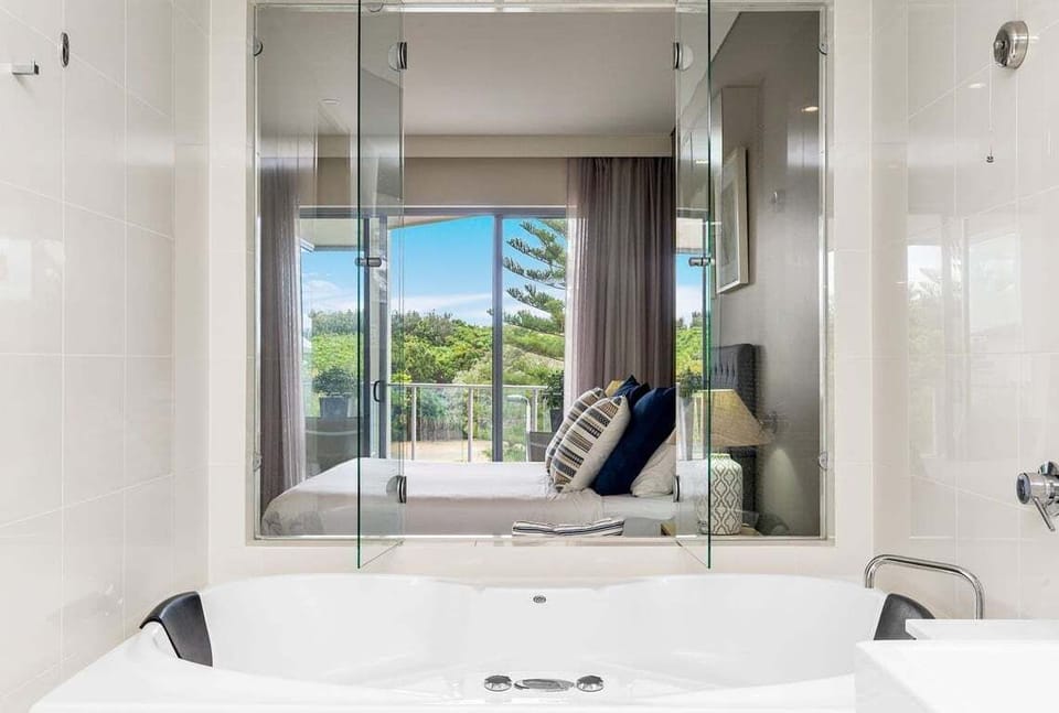 Your first bedroom — a calming space designed for rest and relaxation, featuring large windows and a soothing ambience.