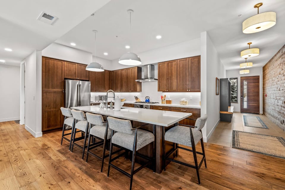 Bright, open-concept kitchen with large island, modern finishes, and ample seating for cooking, dining, and relaxing together.