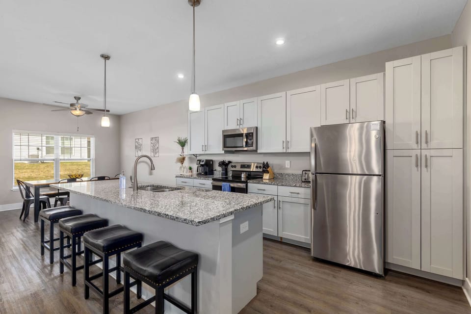 Bright, open kitchen featuring an eat-in island—perfect for meals, snacks, or gathering with friends and family.