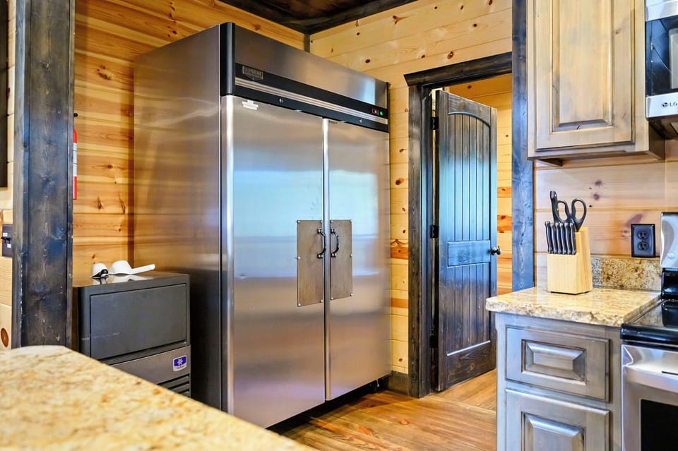 Commercial refrigerator and ice machine. Deep freeze is located on the other side of the door pictured that accesses the laundry room.