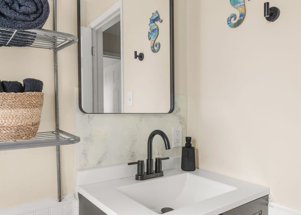 Bathroom: Modern vanity with stylish black fixtures
