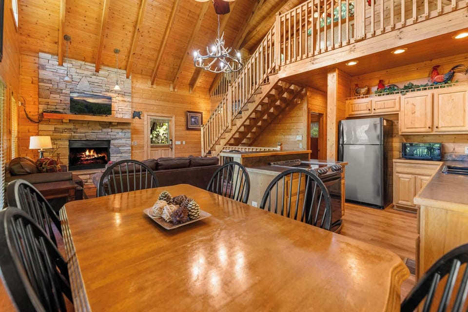 Spacious dining area with rustic wood table, perfect for family meals.