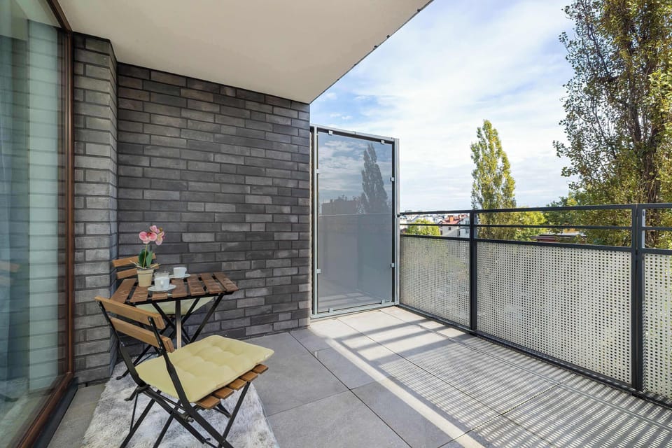The balcony with a comfortable seating set is the perfect spot for a morning coffee in the sun or an evening moment of relaxation outdoors.