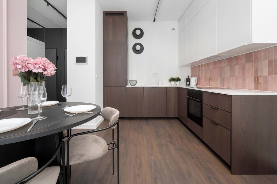 The sleek design of the kitchenette blending seamlessly with the living area.