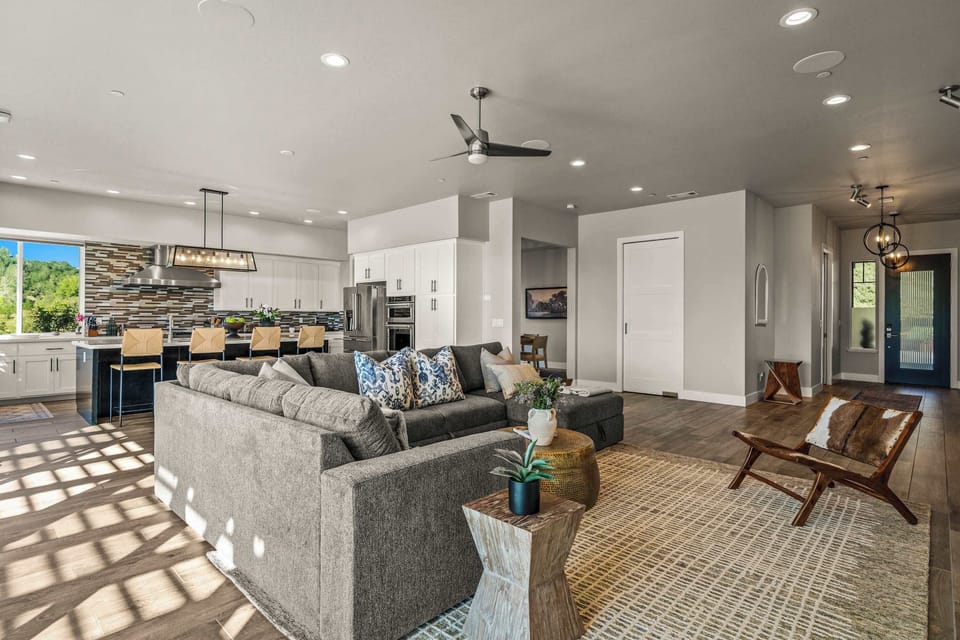 Bright, cozy space with comfy seating, warm natural light, and an easy open layout perfect for hanging out. Enjoy a stylish kitchen with bar seating and plenty of room to relax, cook, or chat—great for families, friends, and laid-back getaways.
