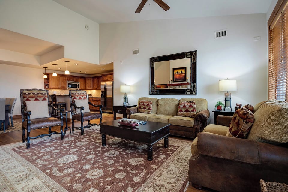 Sink into plush leather armchairs and relax in your spacious living room, complete with warm Southwest decor and open kitchen for effortless entertaining.