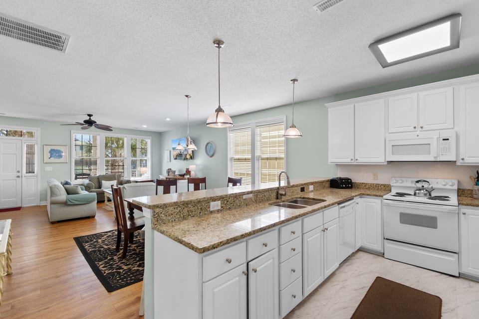 Your spacious open-concept kitchen flows seamlessly into the living area, perfect for cooking and socializing together.