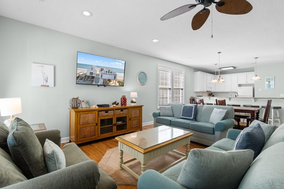 Relax in this inviting living room with coastal colors, comfy seating, and open layout flowing to your kitchen.